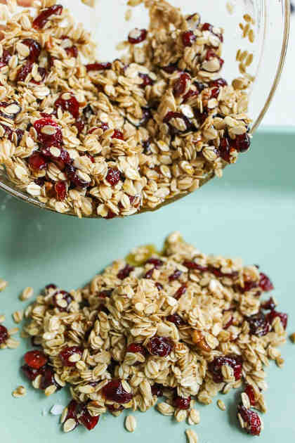 The main ingredient in granola is rolled oats though other grains such as millet and quinoa can be added. Combined with nuts, seeds and dried fruits, the mixture is then tossed with a sweetener like honey or maple syrup and fat, for instance, olive oil or butter. Both sweetener and fat act as a binding agent and once baked gives you clusters of crispy goodness.